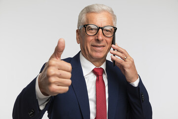 Businessman giving ok sign and showing the conversation went ok