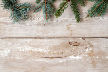 Festive Christmas decoration, fir and spruce twigs on a rustic wood background