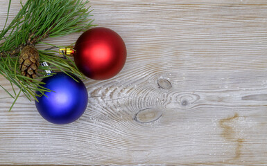 Christmas decoration, fir and spruce twigs, pine cones and baubles, on a rustic wooden background, space for text, Christmas background