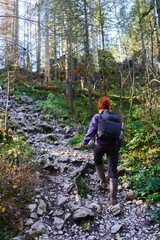 Woman hiking on a trail in the mountains