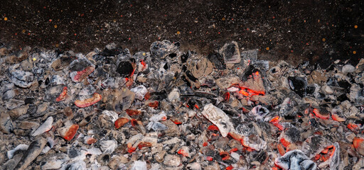 Burning charcoal. Flaming coal close-up. Sparks from the fire