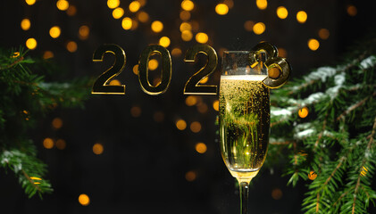 New Year's background, a postcard with a glass of champagne and the numbers 2023 on a dark...
