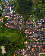 Naklejka premium Jerico Cityscape Colonial Houses and Green Meadows and A Christ Statue on A Hill