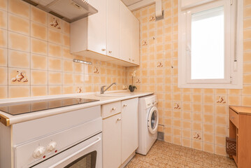 Kitchen with white wooden furniture with matching countertop and small yellow tiles