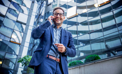 Businessman making a phone call in front of the corporation. Business, lifestyle concept