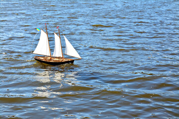 model of a sailboat in water waves