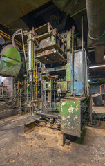 An old industrial machine in a stopped factory for the production of cast iron car parts