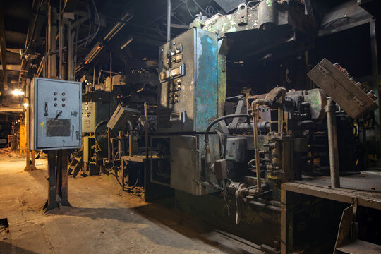 An old industrial machine in a stopped factory for the production of cast iron car parts