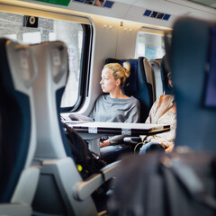 Blonde casual caucasian lady traveling by train.