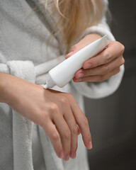 a woman applying a hand cream