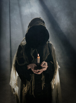 Person in spooky Hallowe'en ghoul costume standing in fog.
