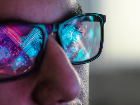 AI Technology, Electronic circuit board reflected in glasses