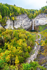 Fototapeta na wymiar The Taughannock waterfalls surrounded by Fall colors