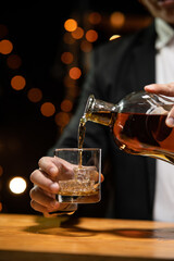 Barman pouring whiskey whiskey glass beautiful night
