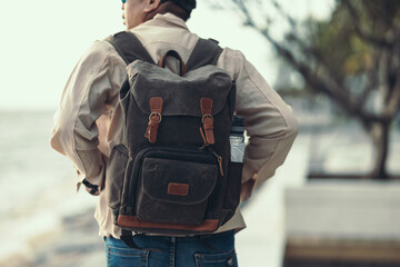 Tourists stand to watch sea sunset. backpacker, travel concept..