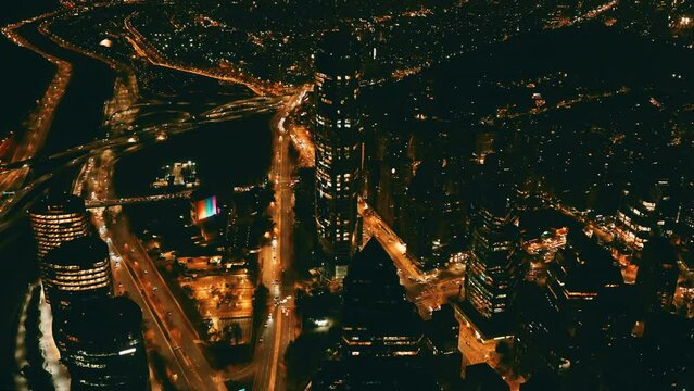City view at night with cars and buildings in motion.