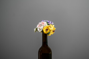 flowers bouquet in the champagne bottle as the symbol of holidays