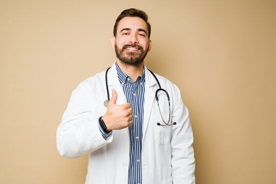 Cheerful male doctor doing a good work and a thumbs up