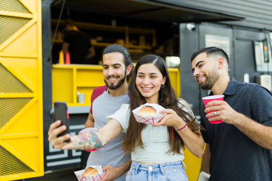 Friends taking a selfie before eating street food from the food truck