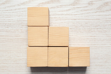 Blank cubes on white wooden table, flat lay with space for text. Idea concept