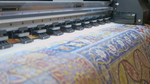 The industrial printer, plotter head slides over the surface of the paper and prints a large image. Closeup