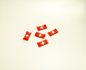 A top-down studio shot of Swiss chocolate pieces isolated against a white background. 