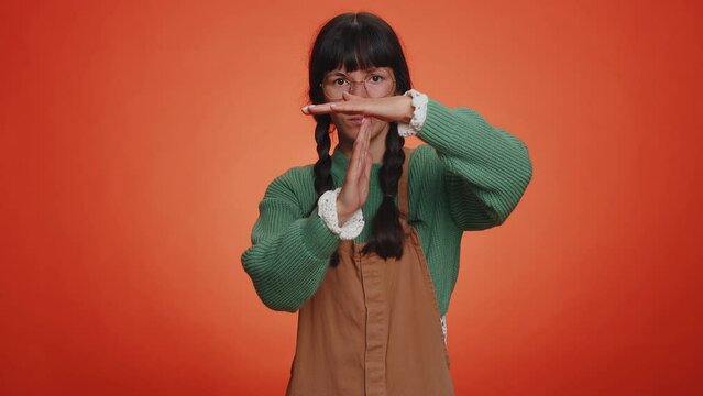 Time out, break. Tired serious upset young nerd woman with pigtails in glasses showing time out gesture, limit or stop sign, no pressure, i need more time. Latin girl isolated on orange background