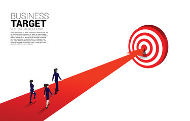 silhouette of businessman and businesswoman walking on arrow to center of dartboard. Business Concept of targeting and customer.Company vision mission.