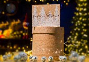 Happy Holidays greeting card on the background of Christmas decor, gift boxes and lights