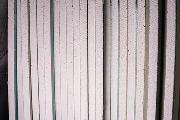 A lot of sheets of moisture-resistant drywall close-up at a construction site. Universal facing...