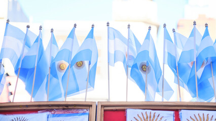 A row of Argentine national flags waving outdoors, patriotic symbol of Argentina.