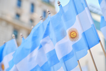Row of Argentine national flags waving outdoors, patriotic symbol of Argentina in a Buenos Aires...