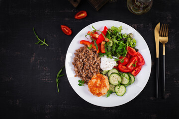 Healthy dinner. Lunch bowl with buckwheat porridge, fried chicken cutlet and fresh vegetable salad. Top view, flat lay