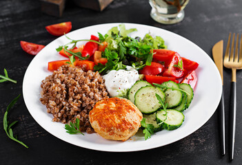 Healthy dinner. Lunch bowl with buckwheat porridge, fried chicken cutlet and fresh vegetable salad.