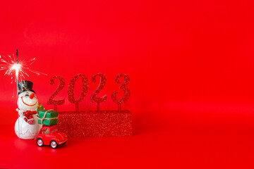Christmas card, glitter and numbers 2023 on a red background with a place to copy. High quality photo