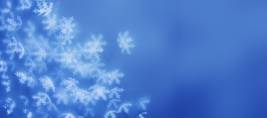 Christmas or New Year abstract magic lights background, white snowflakes bokeh on blue as winter holiday backdrop. Xmas mood aesthetic photo, blurred effect, celebration illumination