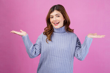 Portrait of Excited surprised young woman celebrating victory with happy smile and winner expression with raised hands isolated over pink background