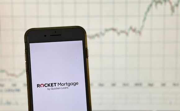 Spokane, WA - USA - February 2021 - Rocket Mortgage App With Stock Graph In The Background.  Rocket Mortgage Is The Online, Mobile Mortgage Application Process Developed By Quicken Loans