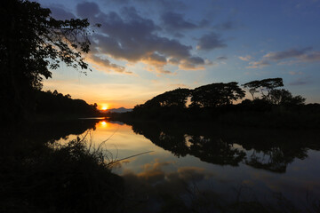 Beautiful view with sunset light in the evening,A beautiful river reflected from the sunset at dusk,Soft focus,selected focus,shallow depth of field.