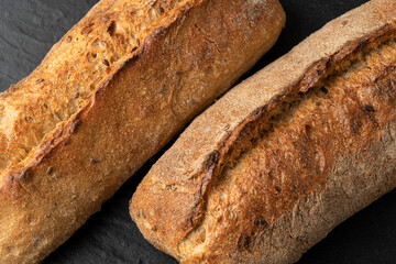 Sourdough bread with crispy crust on wooden shelf. Bakery goods
