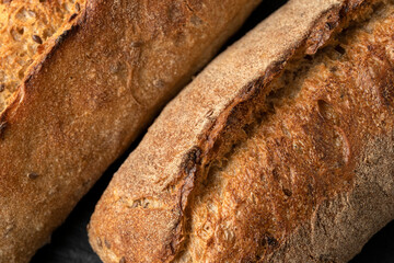 Sourdough bread with crispy crust on wooden shelf. Bakery goods