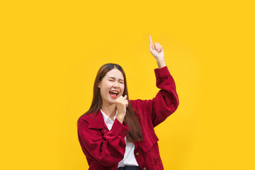 Women are using hands as microphone and singing the song over isolated yellow background