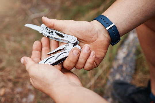 Hands, man or multi purpose knife in environment camping land, sustainability forest woods or hiking mountains. Zoom, hiker or swiss army blade, survival tools or metal equipment gear in nature earth