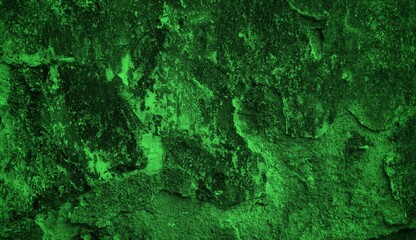 A textured green grunge background with dark patches and rough surface