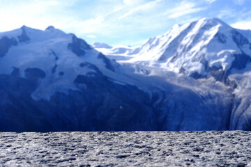Stone Table (Selective Focus at Surface) with Blurred Snow Mountain at Gornergrat Cable Station Background, Suitable for Product Presentation Backdrop, Display, and Mock up.
