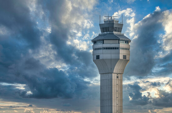Airtraffic control tower against dramatic cloudy sunset sky