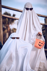 Halloween, friends and ghost costume for fun, festival and celebration while bonding at park, happy...