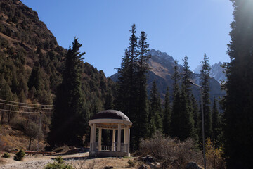 gazebo among TREES against the backdrop of mountains