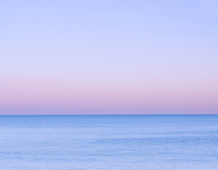 Gradient purple blue sunrise over sea