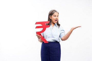 Indian senior lady holding rupees symbol in hand on white background.